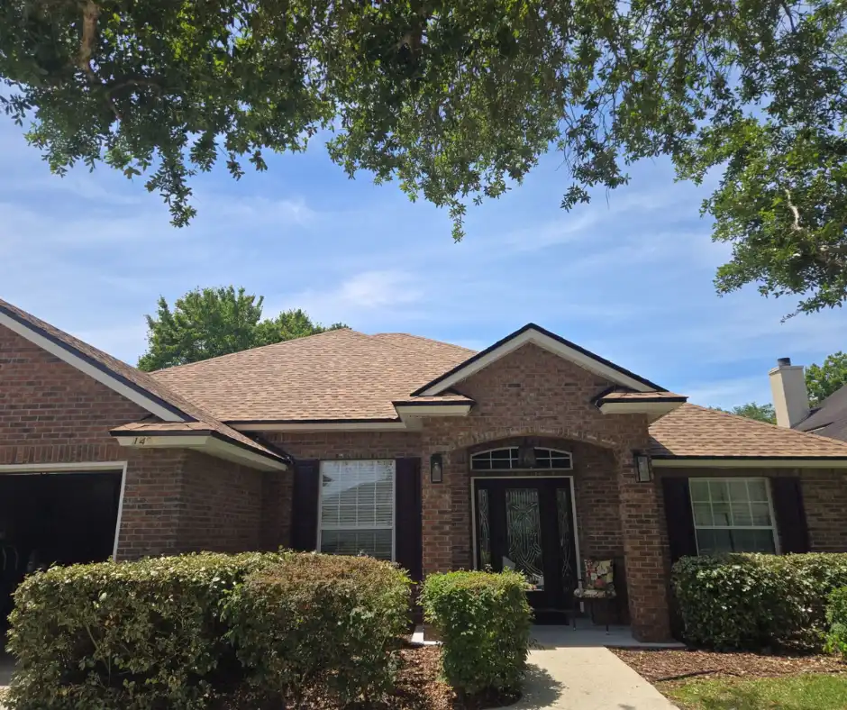 Brick home, tan shingle, hip roof, front angle